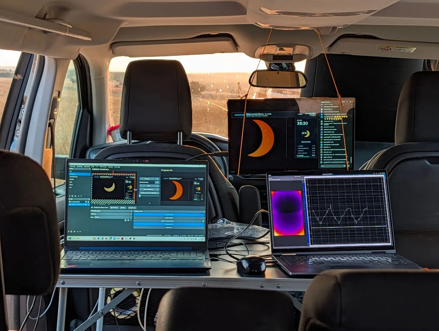 Mobile control desk in the car with OBS, the Planetum stream and live sensor data during the partial phase
